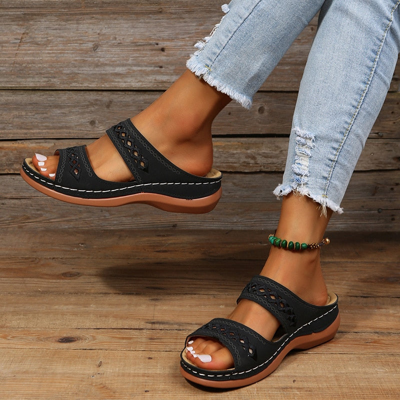 Alice black double strap slide sandals with decorative cutout details and a comfortable brown sole.