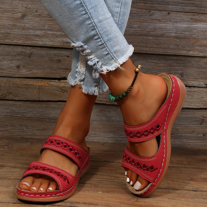 Alice women's red double strap slide sandals with decorative cutout detailing, worn with jeans.