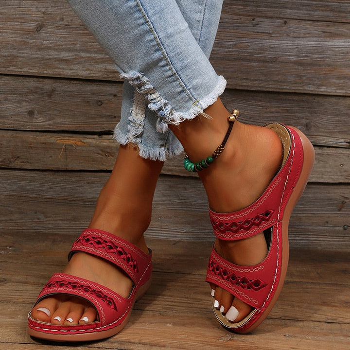 Alice women's red double strap slide sandals with decorative cutout detailing, worn with jeans.