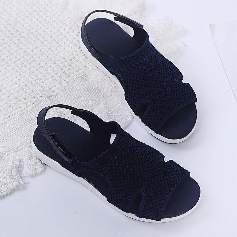 Amiel women's navy open-toe slingback sport sandals with soft knit-style upper and sporty white sole.