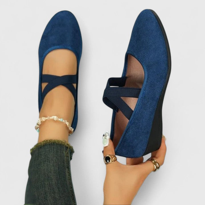 Clara women's navy orthopedic wedge strap flats with a closed toe and secure cross-strap design.