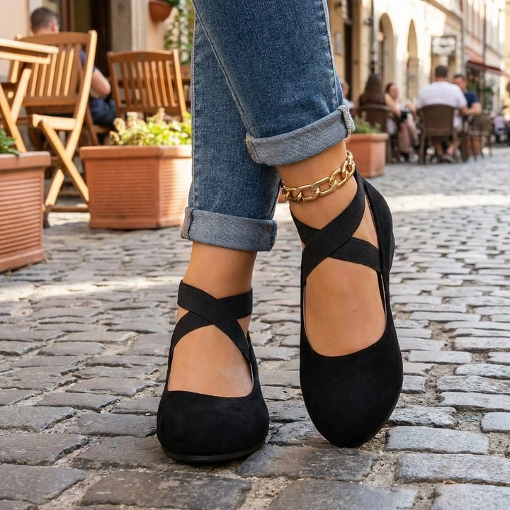 Clara black orthopedic wedge strap flats with secure cross-strap design for everyday comfort and subtle lift.