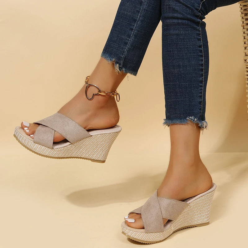 Women's Cora beige wedge slide sandals with crossed front straps and textured sole.