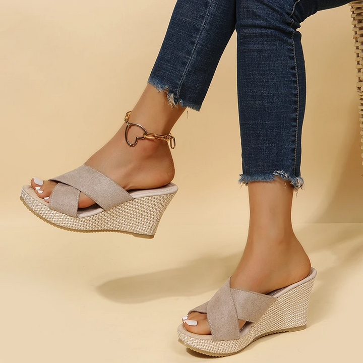 Women's Cora beige wedge slide sandals with crossed front straps and textured sole.