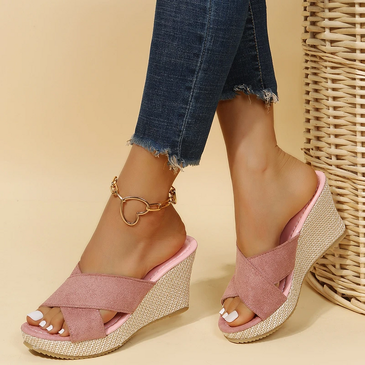 Women's Cora pink wedge slide sandals with crossed front straps and a textured woven sole.