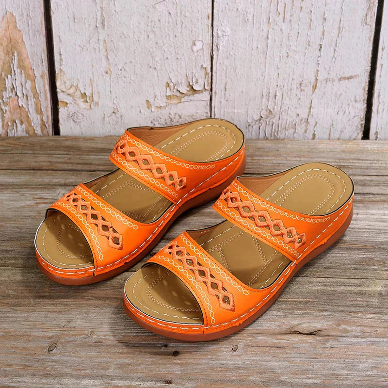 Vibrant orange Ezra women's open-toe slip-on wedge sandals with cutout strap detailing for effortless style.