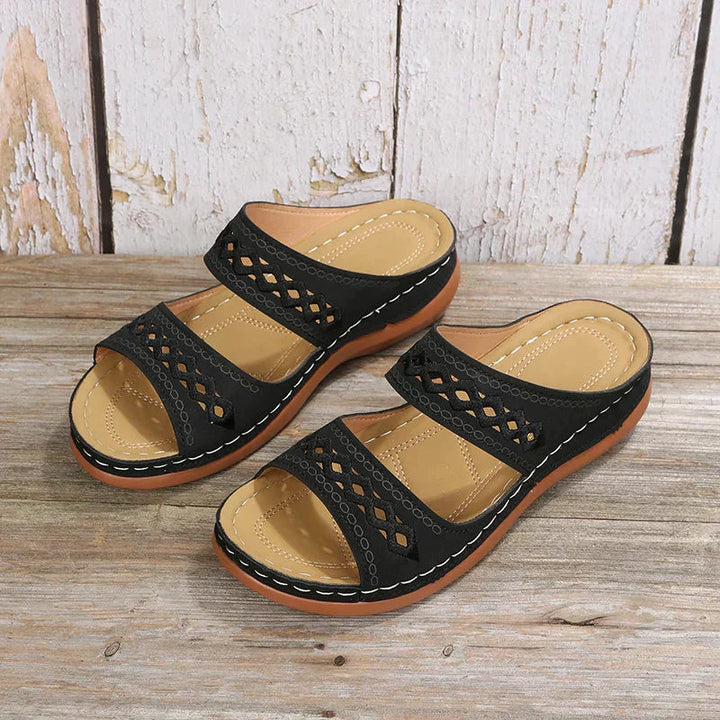 Black Ezra women's open-toe slip-on wedge sandals with cutout strap detailing and a low wedge sole.