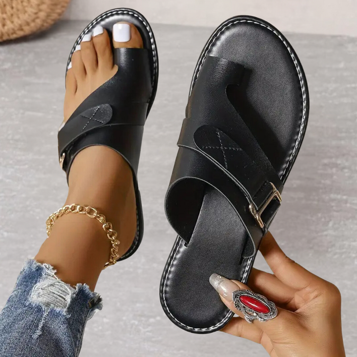 Black Jessamine women's toe loop slide sandals with wide crossover strap, buckle detail, and flat sole.