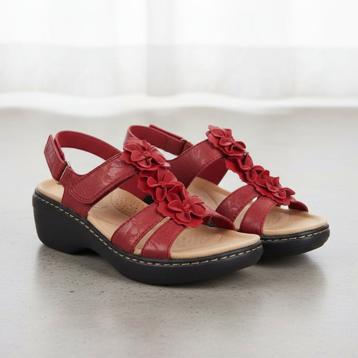 Loveleen red floral wedge sandals with adjustable strap, open toe, and soft decorative accents.