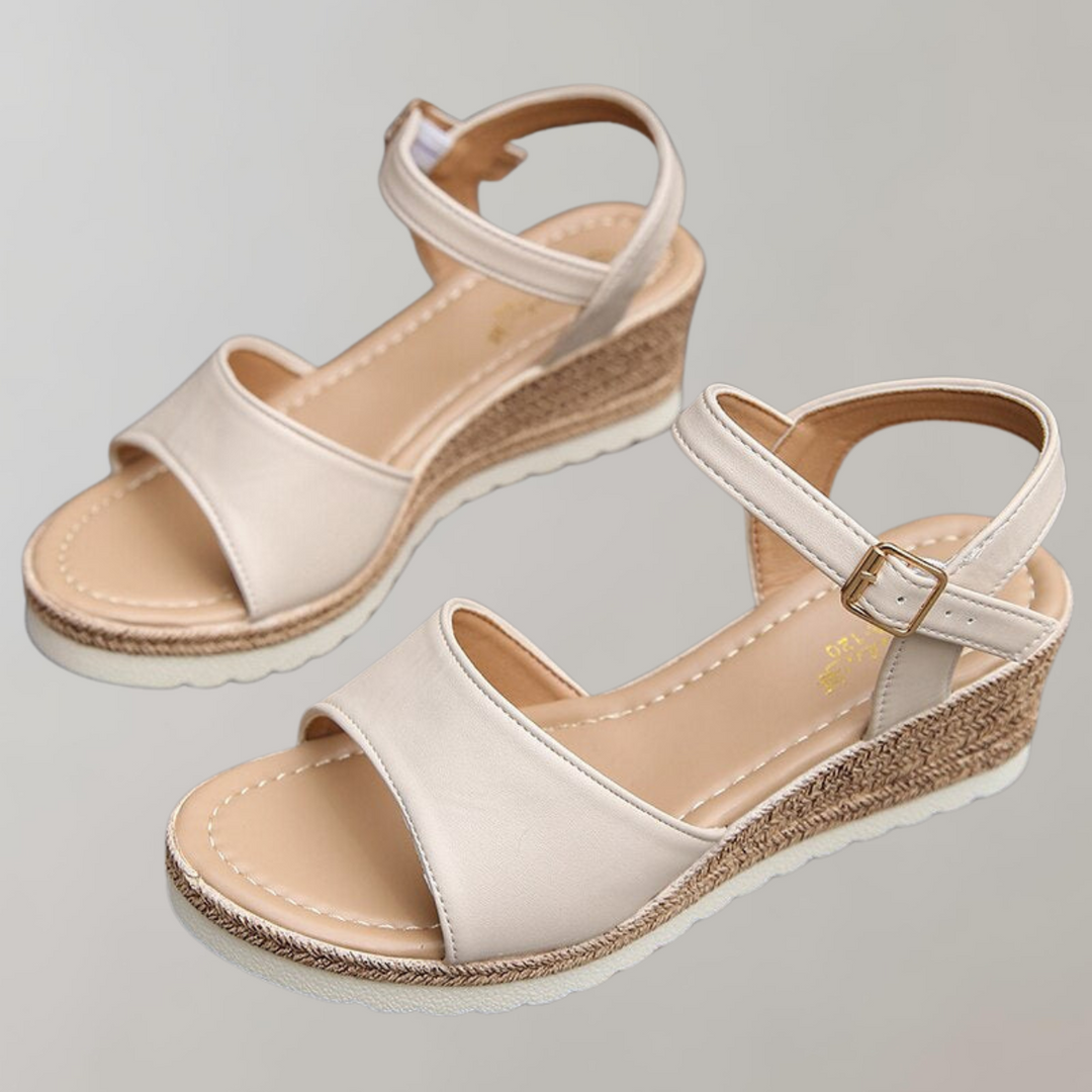 Lucia women's wedge ankle strap sandals in a light beige with smooth front straps and a textured wedge sole.