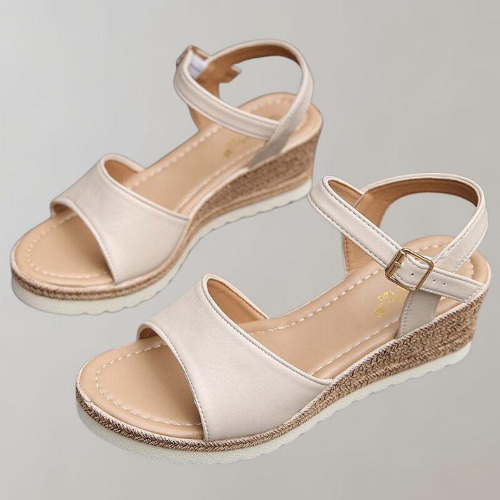 Lucia women's wedge ankle strap sandals in a light beige with smooth front straps and a textured wedge sole.