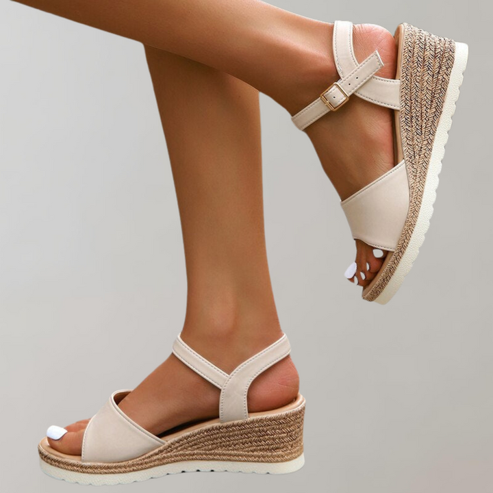 Lucia women's beige wedge ankle strap sandals with textured sole and open-toe design.