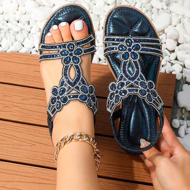 Marcella women's navy beaded T-strap sandals with sparkling blue embellishments and metallic finish.