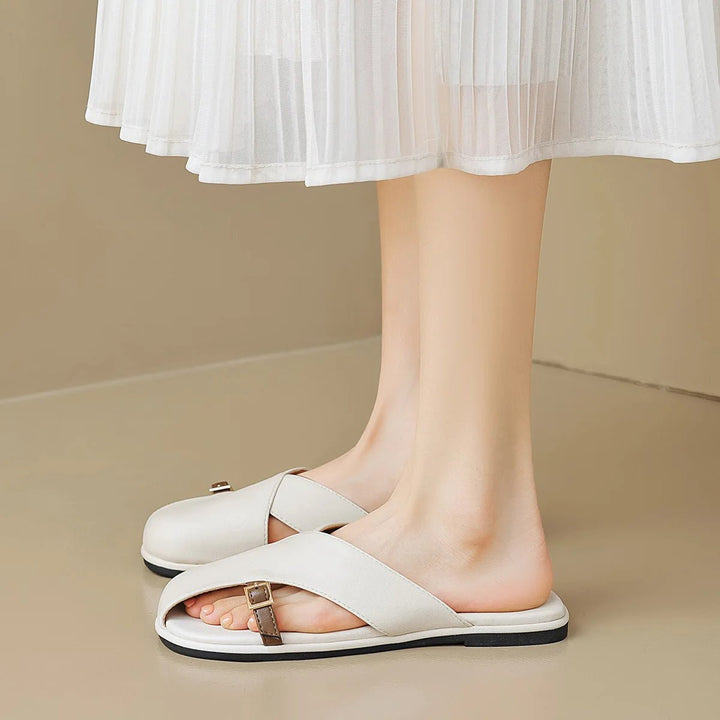 Marzella women's white cross strap slide sandals with a slim buckle detail, perfect for warm-weather outfits.