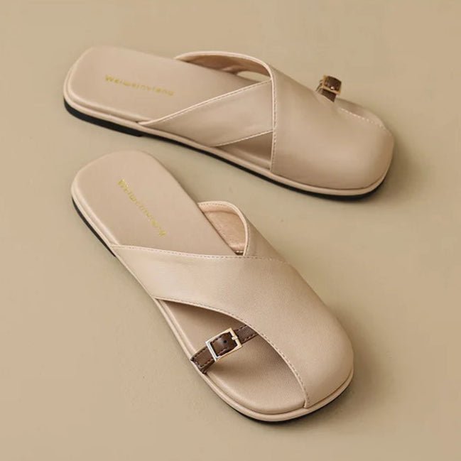 Marzella women's beige cross strap slide sandals with a slim buckle detail for effortless style.