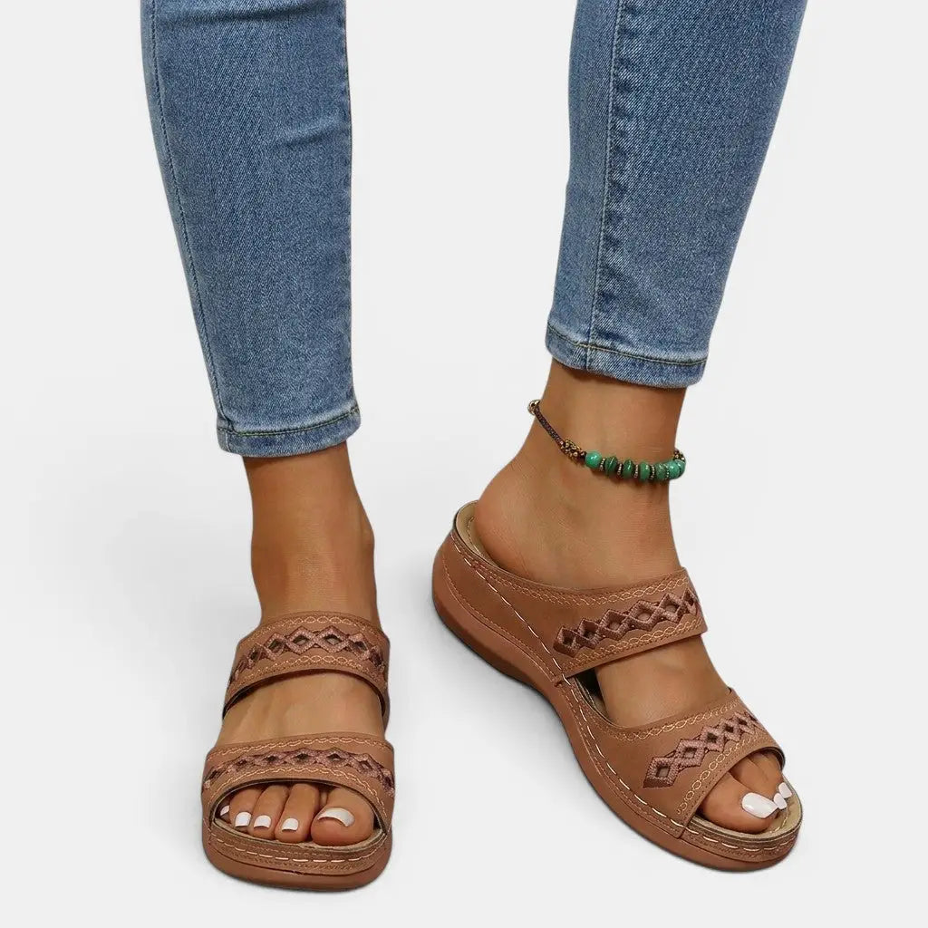 Mia women's brown double strap orthopedic slide sandals with cutout detailing and cushioned sole.