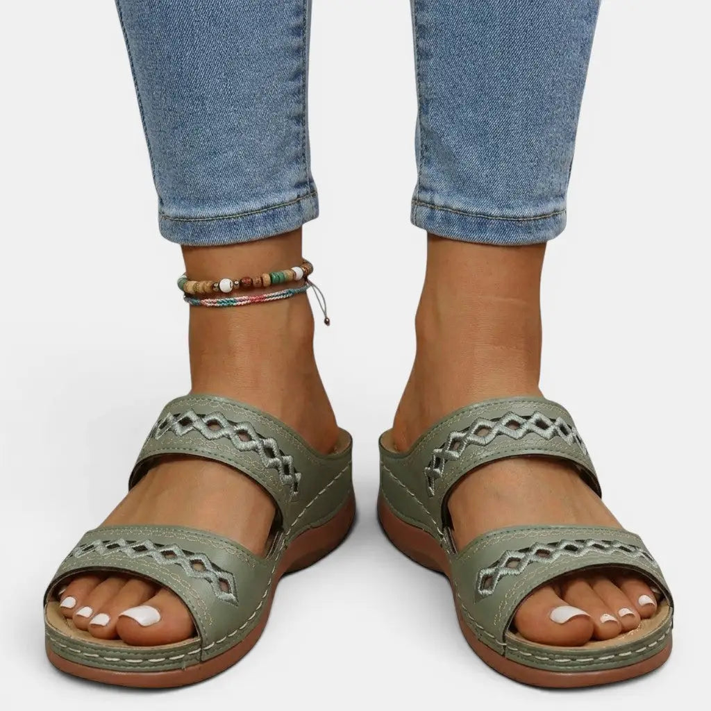 Mia women's olive green double strap orthopedic slide sandals with cutout detailing and cushioned sole.