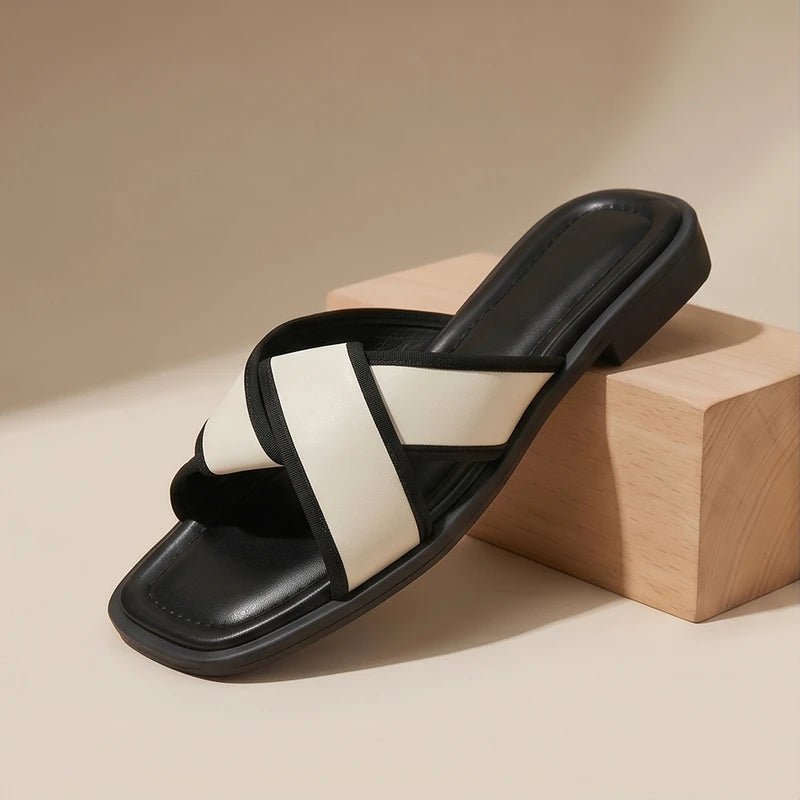 Nerissa women's cross strap slide sandals in black and white with a square toe and contrast trim.