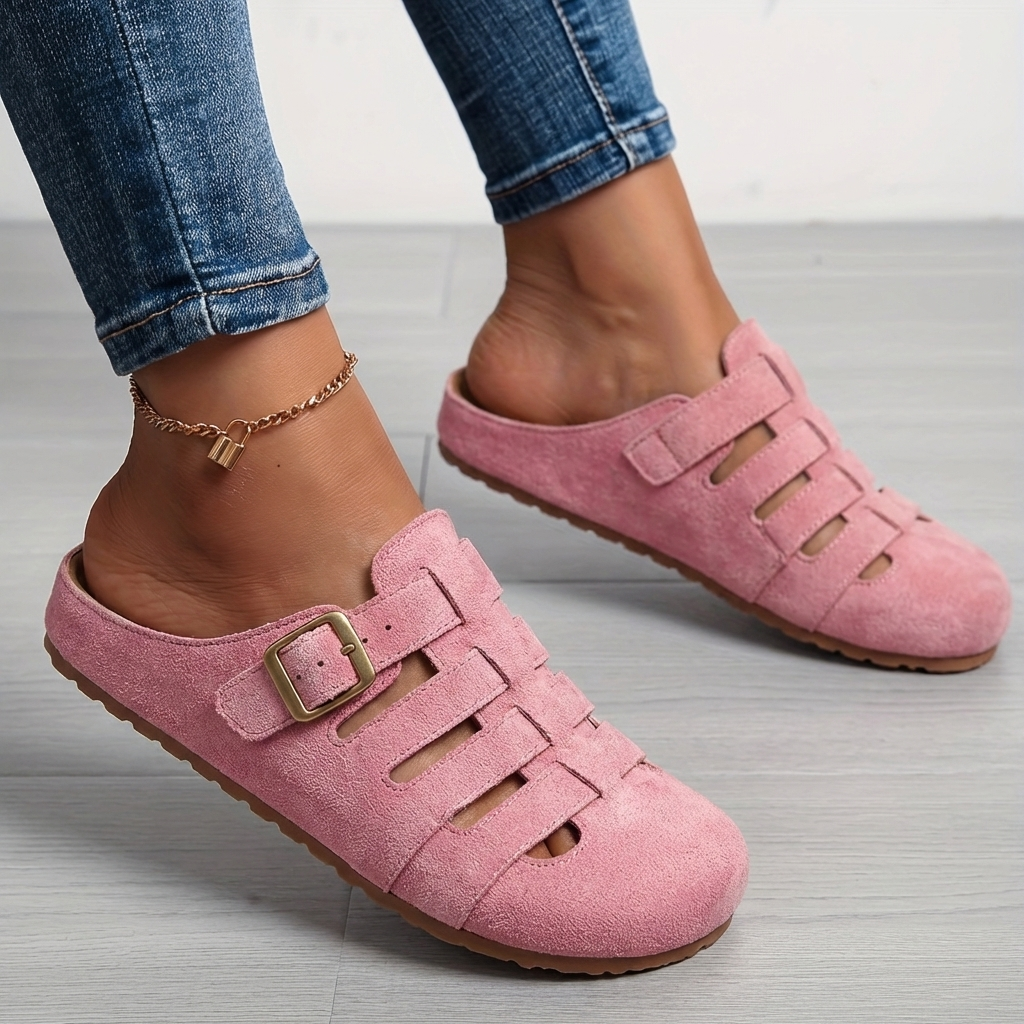 Nora women's pink suede buckle strap slip-on mule sandals with closed toe and cutout detailing.