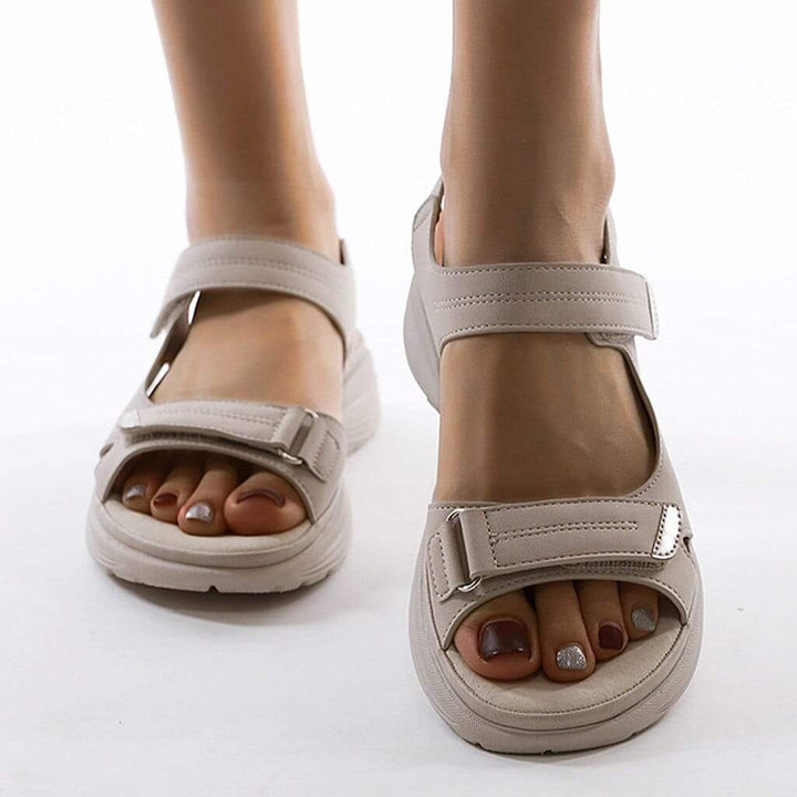 Orlena women's adjustable wedge sandals in a versatile beige, featuring an open toe and secure strap styling.
