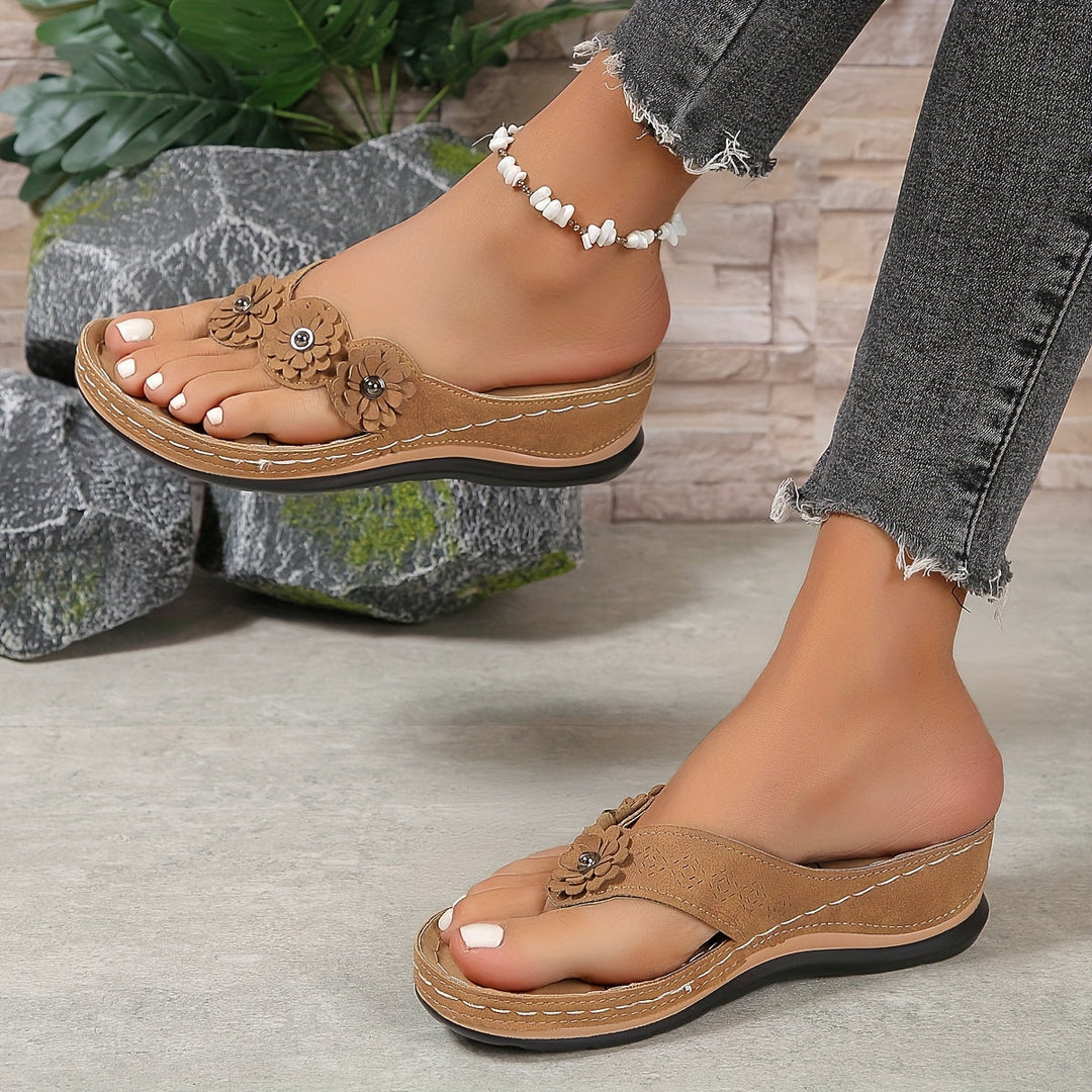 Pippa women's tan floral slide sandals with layered flower details, contrast stitching, and a low sole.