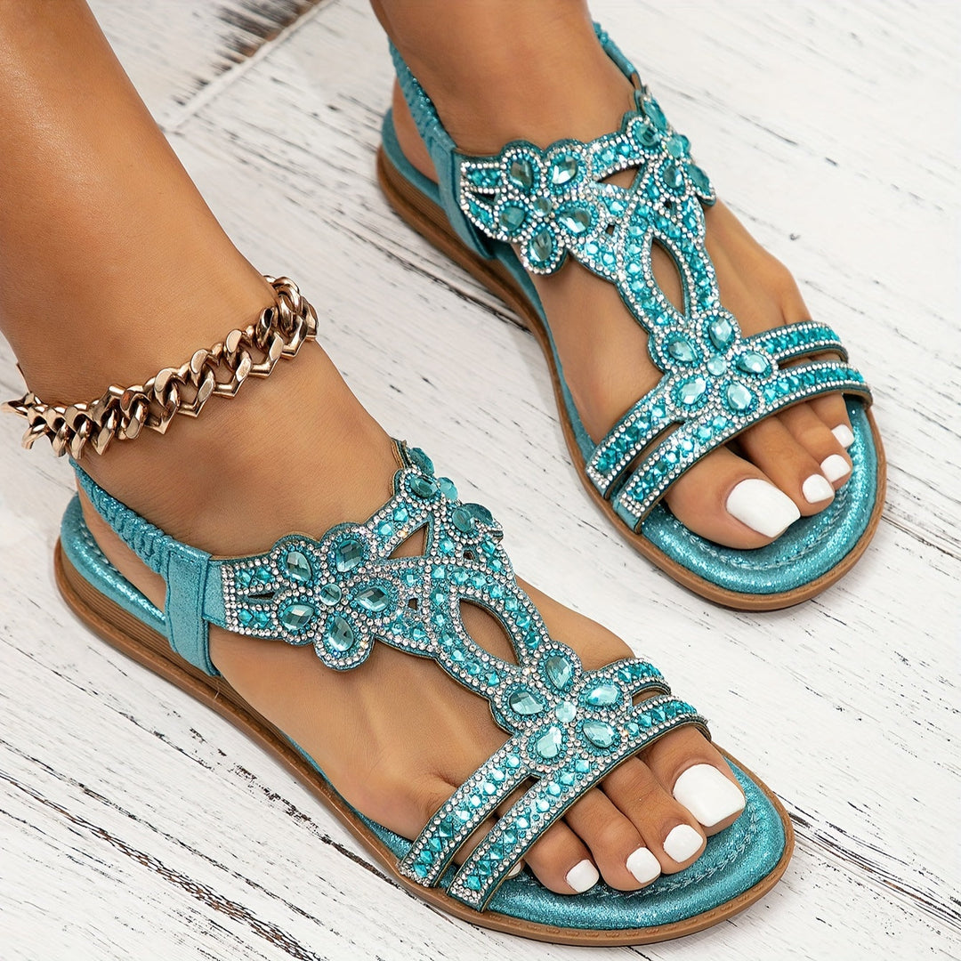 Sapphira women's flat sandals in turquoise with ornate beaded detailing and an open toe design.