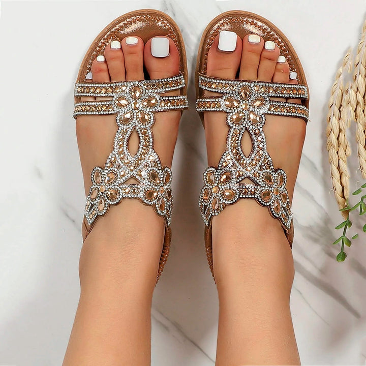Women's Sapphira flat sandals with ornate gold and silver beaded detailing on a warm-weather open-toe design.