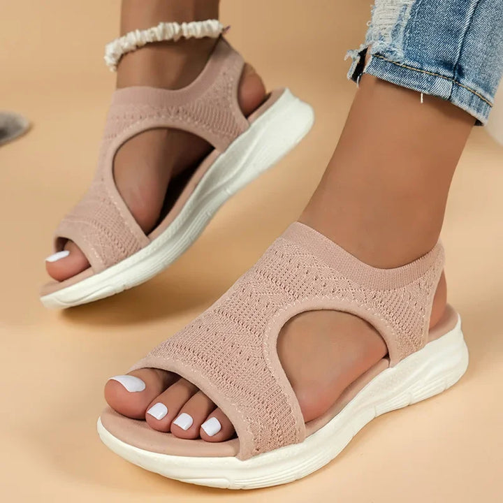 Women's Soleil knit slip-on sandals in blush pink with an open toe, side cutouts, and a cushioned white sole.