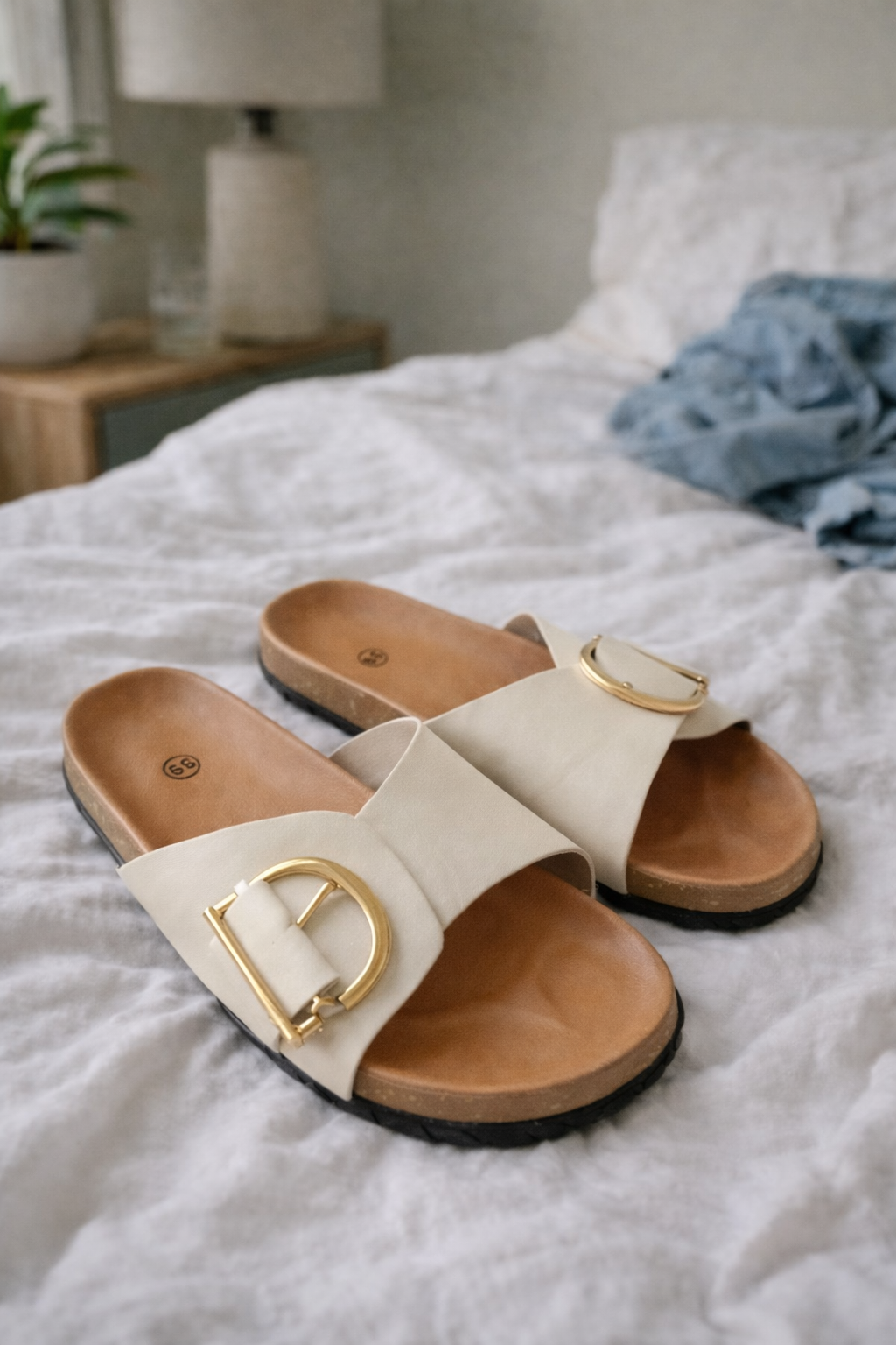 Sylvie women's buckle slide sandals in cream with a wide strap, open toe, and gold-tone buckle detail.