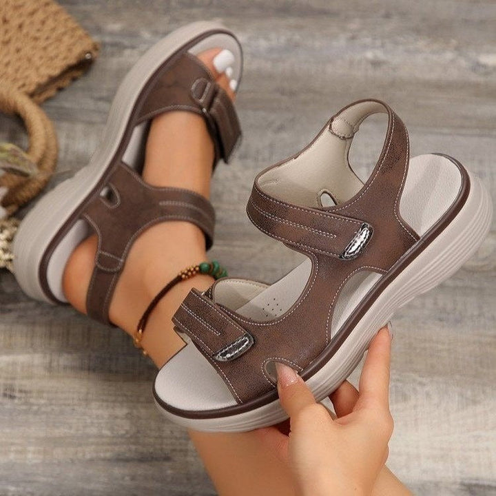 Xaviera women's brown adjustable platform sandals with contrast stitching, open toe, and secure strap styling.