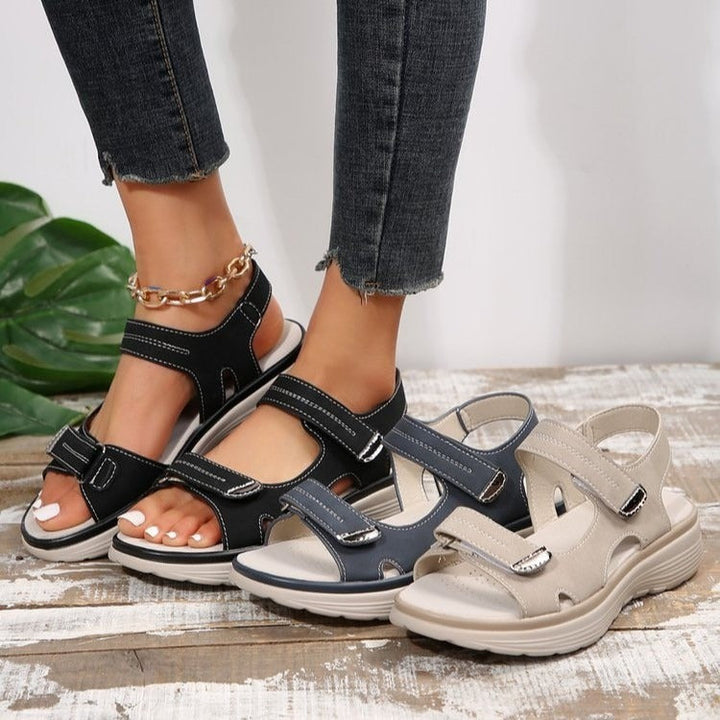 Women's Xaviera adjustable platform sandals in black, navy, and beige with contrast stitching.