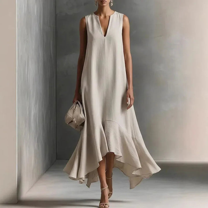 Adeline women's flowy maxi dress in natural linen with a deep V-neck and ruffle hem.