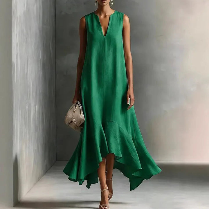 Adeline women's flowy green maxi dress with deep V-neck, sleeveless cut, and ruffle hem.
