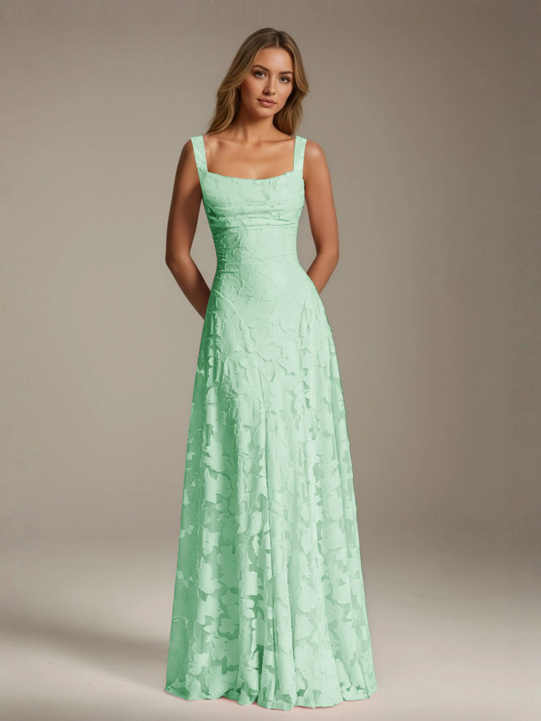 Adrienne mint green floral lace A-line bridesmaid gown with square neckline.