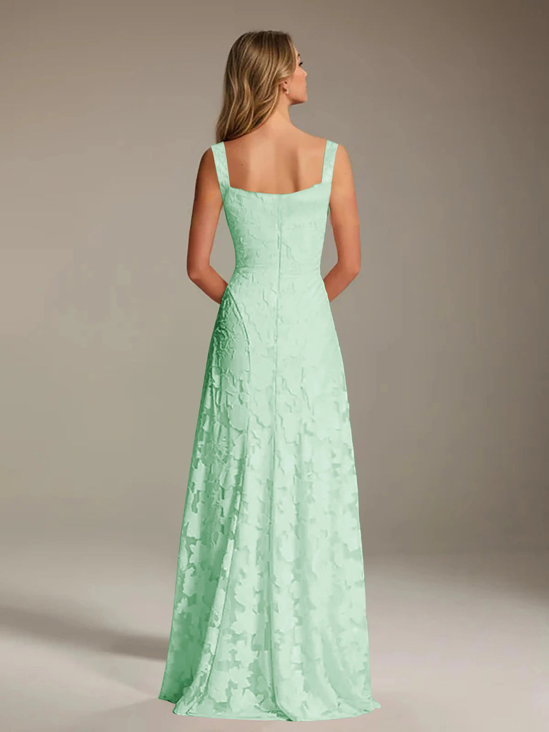 Adrienne mint green floral lace A-line bridesmaid gown with square neckline, seen from the back.