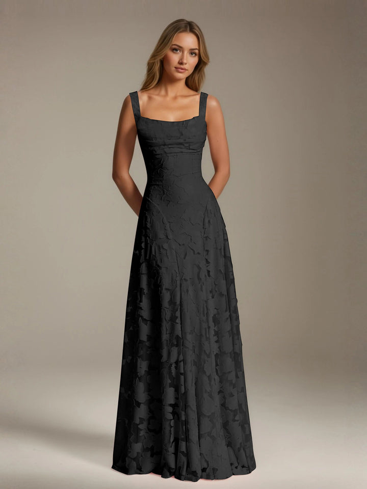 Woman in a black floral lace A-line bridesmaid dress with a square neckline.