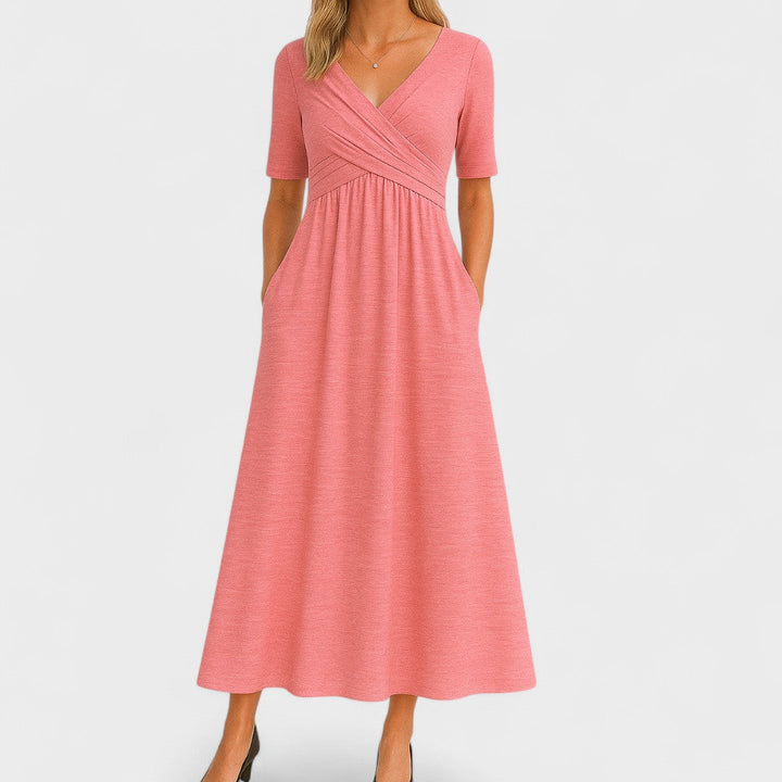 Amaya women's V-neck summer midi dress in coral pink with wrap bodice, elbow sleeves, and side pockets.