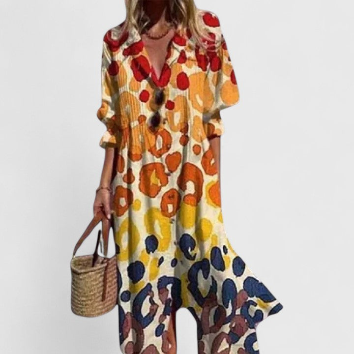 Aria women's boho maxi dress with bold, colorful animal print, long sleeves, and flowing silhouette.