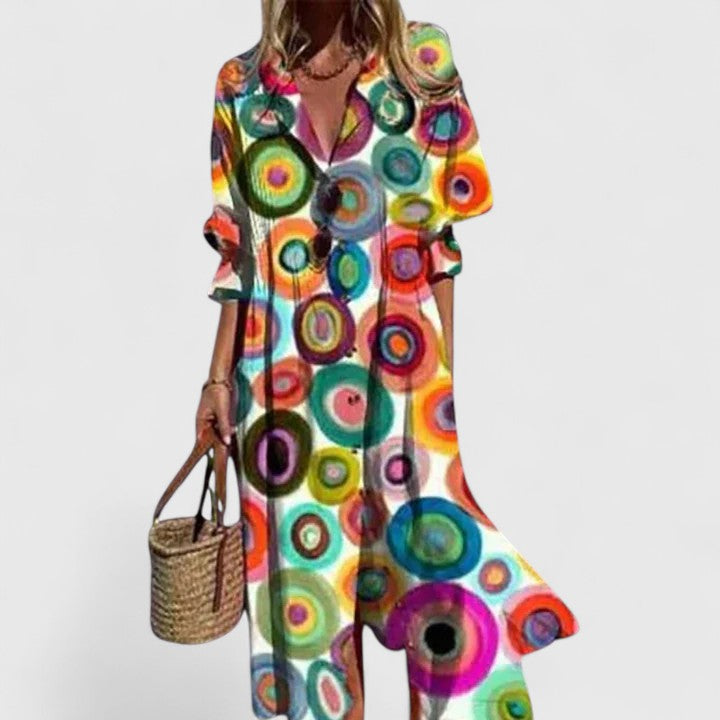 Aria women's boho maxi dress with bold, colorful circle print, long sleeves, and flowing silhouette.