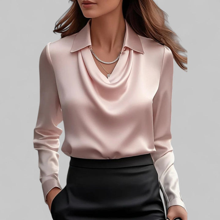 Woman wearing the Aria pale pink satin blouse with a draped cowl neckline and collar.