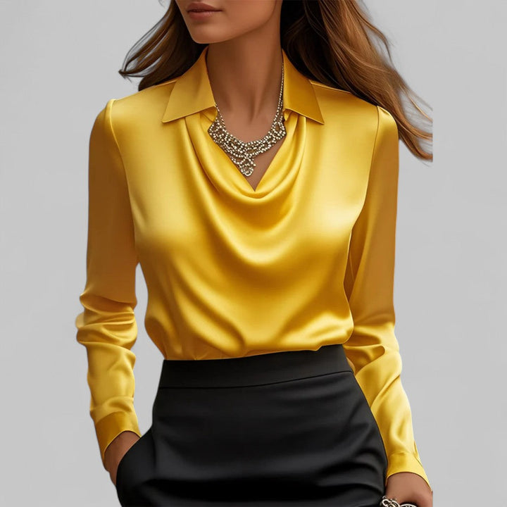 Woman wearing the Aria yellow satin blouse with a draped cowl neckline and collar.