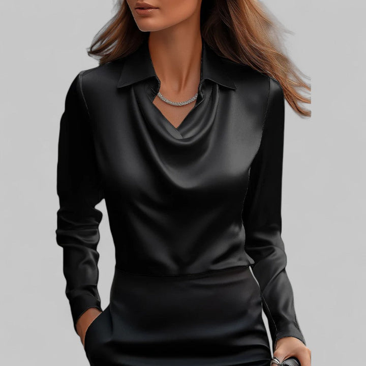 Woman wearing the Aria black long-sleeve satin blouse with a draped cowl neckline and collar.