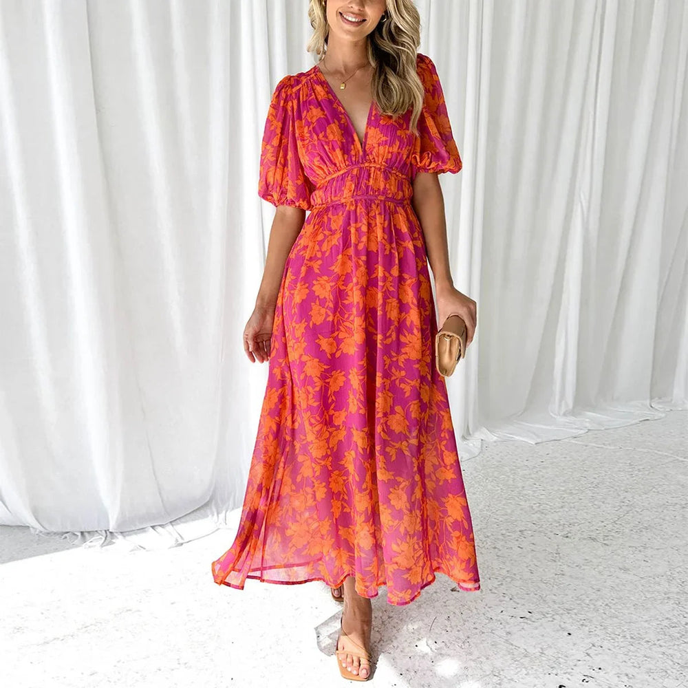Aria Women's Floral V-Neck Maxi Dress in vibrant pink with orange flowers, short sleeves, and flowing silhouette.
