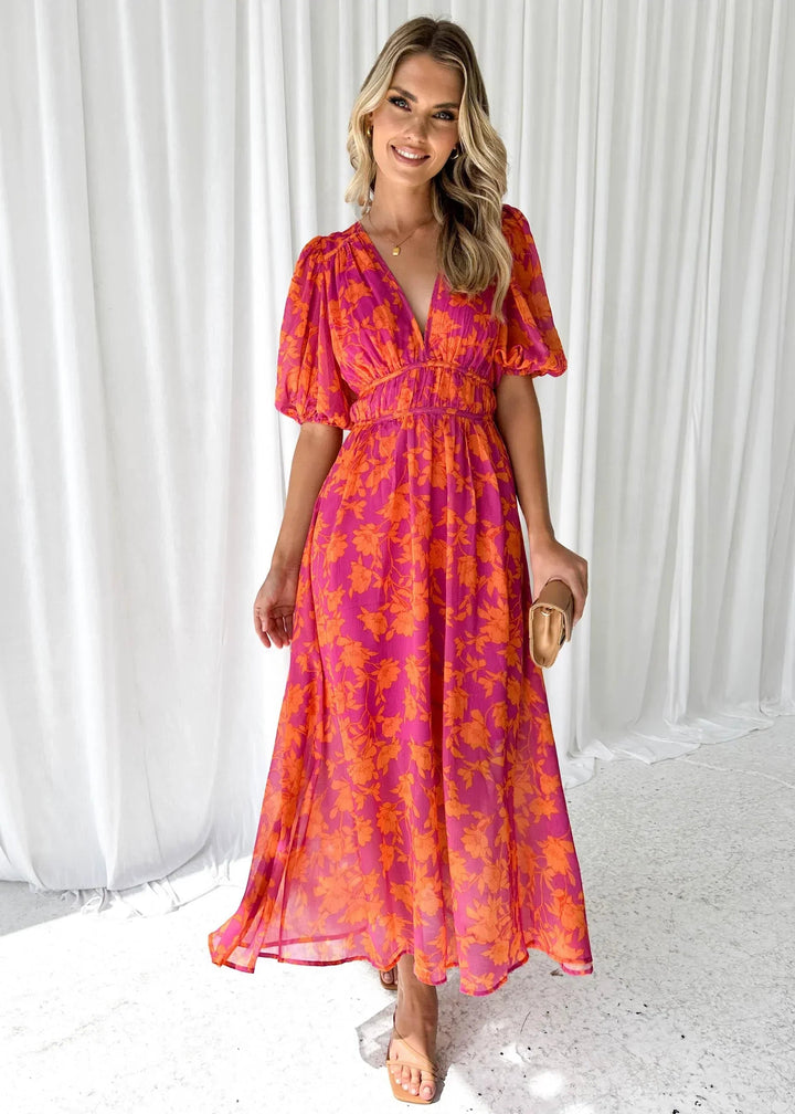 Aria Women's Floral V-Neck Maxi Dress in vibrant pink with orange florals, short sleeves, and flowing silhouette.