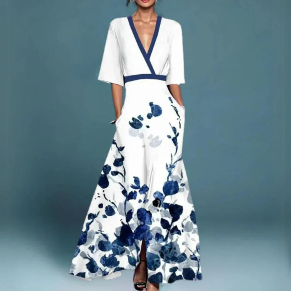Aurelia women's white floral maxi dress with blue print, V-neck, and flowing silhouette.