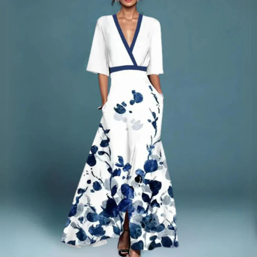 Aurelia women's white floral maxi dress with blue print, V-neck, and flowing silhouette.