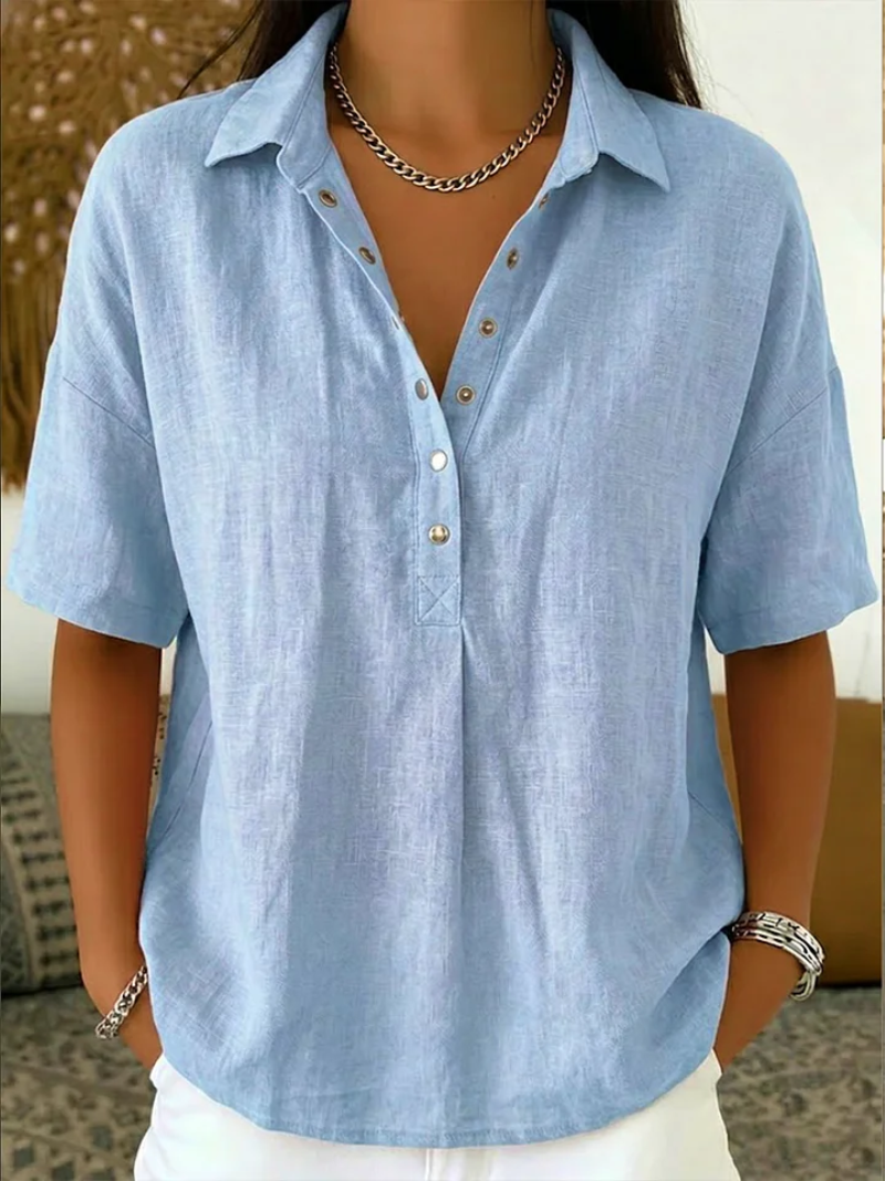 Ava women's light blue collared button-up shirt with short sleeves, relaxed fit, and gold buttons.