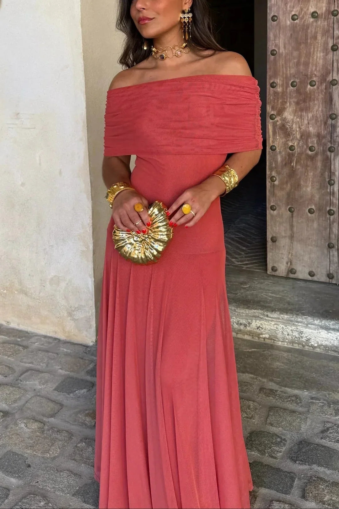 Aviana women's one-shoulder maxi dress in solid coral, with draped bodice and flowing skirt, styled with gold accessories.