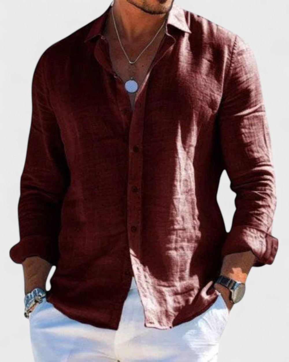 Men's Blake burgundy linen button-up shirt with classic collar, paired with white pants.