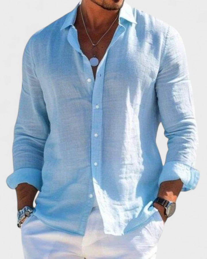 Men's Blake light blue linen button-up shirt, straight cut, classic collar, with sleeves rolled up, paired with white pants.